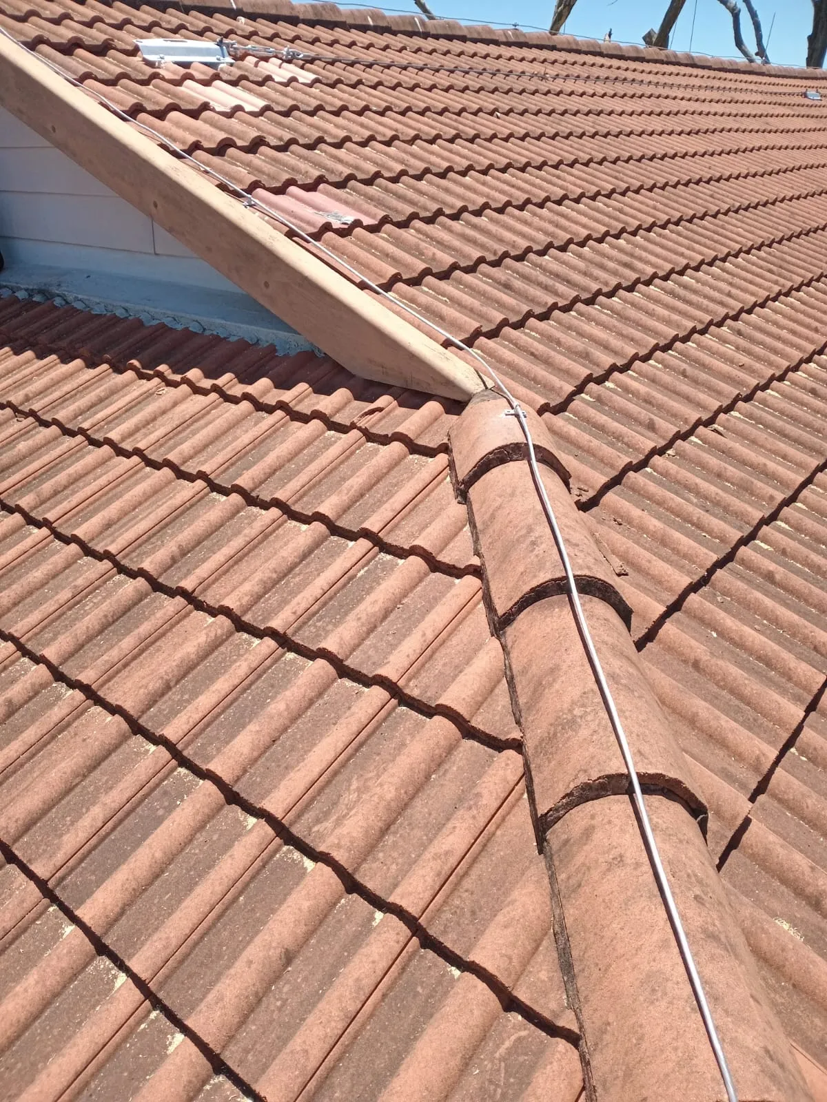Lightning protection conductors and fittings on a tiled roof.